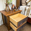 Wooden nightstand with open drawer in a bedroom setting. Black Hills Two Drawer Nightstand available at Rustic Ranch Furniture and Decor.