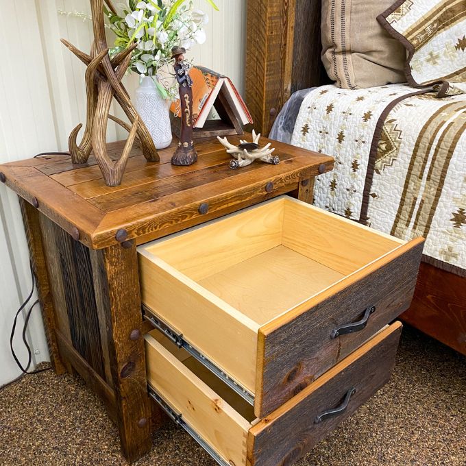 Wooden nightstand with open drawer in a bedroom setting. Black Hills Two Drawer Nightstand available at Rustic Ranch Furniture and Decor.
