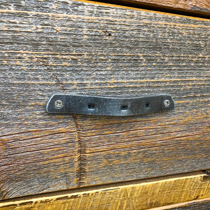 Hand-forged drawer pull on a wooden surface. Black Hills Two Drawer Nightstand available at Rustic Ranch Furniture and Decor.