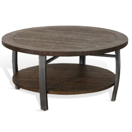 Round wooden coffee table with a lower shelf on a white background.  Homestead Round Coffee Table available at Rustic Ranch Furniture and Decor.