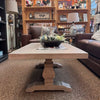 Wooden coffee table table with a decorative arrangement in a room with furniture and decor. Gianna Coffee Table available at Rustic Ranch Furniture and Decor.