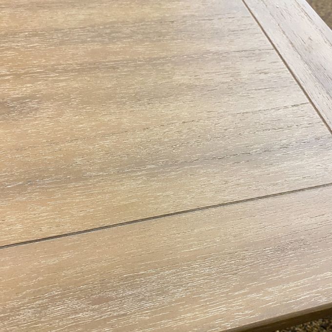 Close-up of a wooden surface with a visible grain pattern. Gianna End Table available at Rustic Ranch Furniture and Decor.