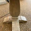 Wooden pedestal base on a gravel surface. Gianna End Table available at Rustic Ranch Furniture and Decor.