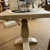 Wooden table with a candle and decorative items on a carpeted floor. Gianna End Table available at Rustic Ranch Furniture and Decor.