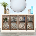 Wooden sideboard with glass doors and decorative items against a light blue wall. Pasadena Media Console - 78" available at Rustic Ranch Furniture and Decor.