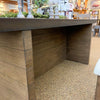 Wooden outdoor furniture with a concrete top in an outdoor setting. Boise Counter Table available at Rustic Ranch Furniture and Decor.