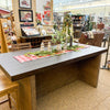 Wooden dining table with festive decorations in a store setting. Boise Counter Table available at Rustic Ranch Furniture and Decor.
