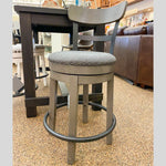 Caitbrook Upholstered Swivel Stools - Two Sizes available at Rustic Ranch Furniture and Decor.