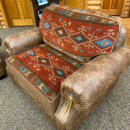 Brown leather chair with patterned cushions in a room setting. Emerson Chair and a Half available at Rustic Ranch Furniture and Decor.