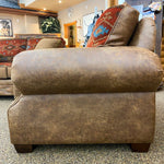Brown leather sofa with patterned cushions in a store setting.  Emerson Chair and a Half available at Rustic Ranch Furniture and Decor.