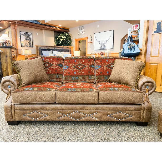 Brown sofa with patterned cushions in a room setting. Emerson Sofa available at Rustic Ranch Furniture and Decor.