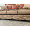 Brown sofa with decorative pillows and studded details on a textured floor.  Emerson Sofa available at Rustic Ranch Furniture and Decor.