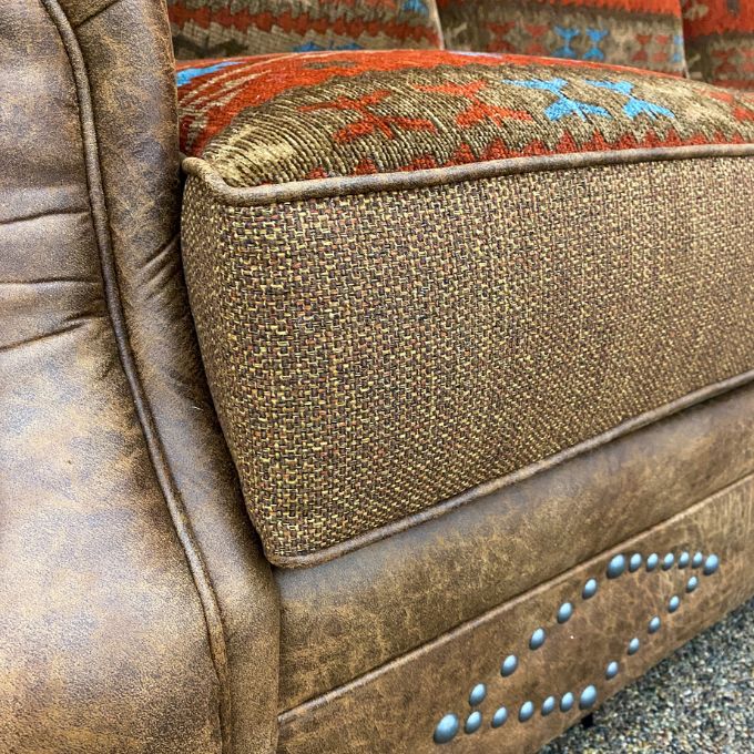Close-up of a textured brown cushion with decorative patterns on a chair. Emerson Chair and a Half available at Rustic Ranch Furniture and Decor.