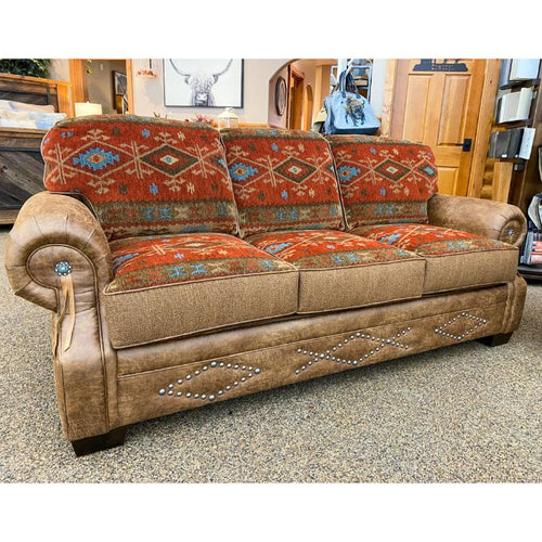 Brown sofa with patterned cushions in a room setting.  Emerson Sofa available at Rustic Ranch Furniture and Decor.