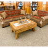 A patterned sofa and a chair with a wooden coffee table in a room with wooden walls.  Emerson Chair and a Half available at Rustic Ranch Furniture and Decor.