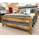 Wooden bed with reclaimed wood in a store setting. Fireside bed available at Rustic Ranch Furniture and Decor.