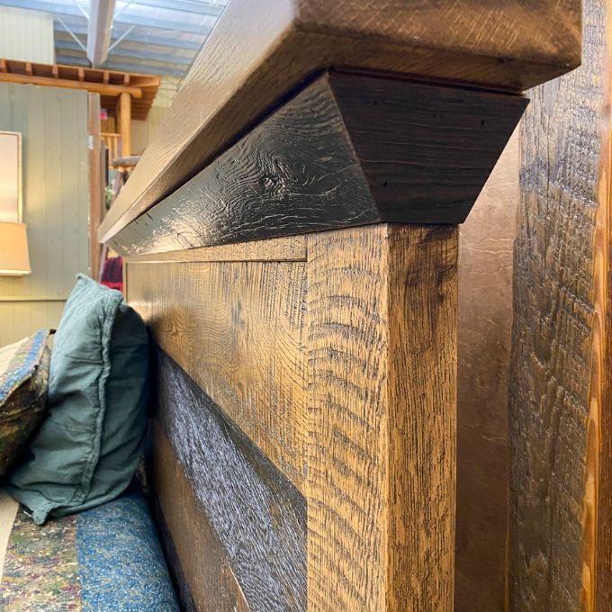 Wooden headboard with a textured finish in a room setting.  Fireside bed available at Rustic Ranch Furniture and Decor.