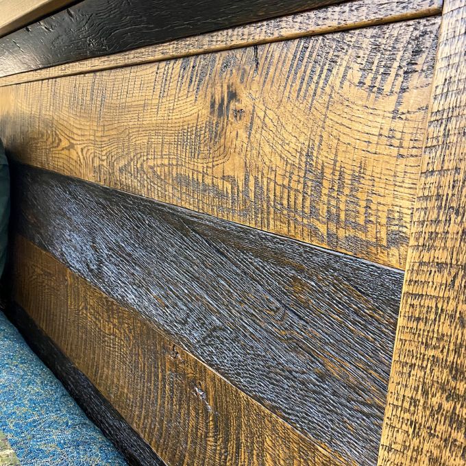 Close-up of wooden panel with a visible grain pattern.  Fireside bed available at Rustic Ranch Furniture and Decor.
