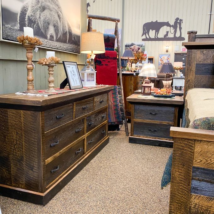 Wooden bedroom furniture in a room with decorative items and wall art. Fireside Reclaimed Wood Seven Drawer Dresser available at Rustic Ranch Furniture and Decor.