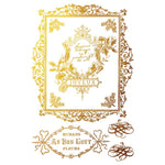 Decorative gold frame with floral elements and text on a white background. Figgy & Flourish Transfer by IOD available at Rustic Ranch Furniture and Decor.
