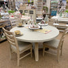 Round dining table with chairs in a store setting. Rowan Round Dining Table available at Rustic Ranch Furniture and Decor.