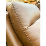 Close-up of a brown leather seat with visible stitching.  Vienna Reclining Love Seat available at Rustic Ranch Furniture and Decor.