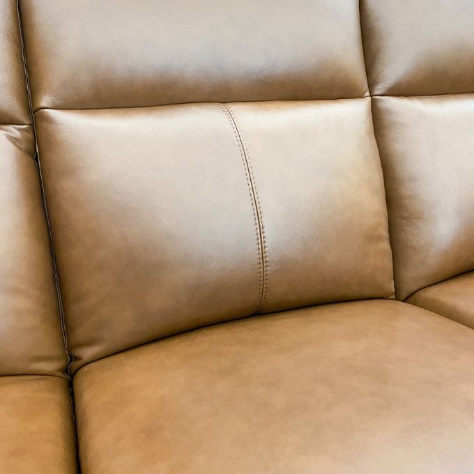 Close-up of a brown leather sofa, Vienna Recliner Sofa available at Rustic Ranch Furniture and Decor.