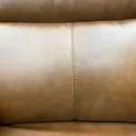 Close-up of beige leather with stitching detail.  Vienna Reclining Love Seat available at Rustic Ranch Furniture and Decor.