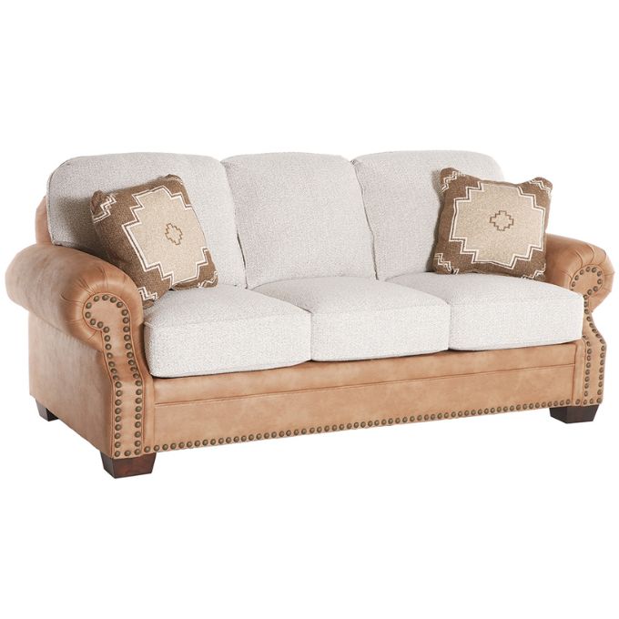 Beige sofa with white cushions and patterned brown pillows on a white background.  Emerson Sofa available at Rustic Ranch Furniture and Decor.