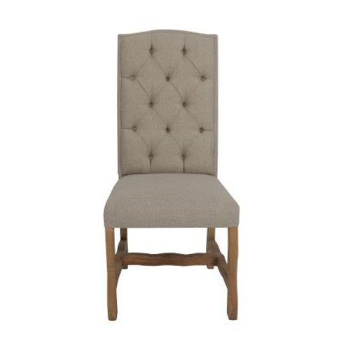 Beige upholstered chair with wooden legs on a white background. Marquez Dining chair available at Rustic Ranch Furniture and Decor.