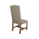Chair with beige upholstered backrest and wooden frame on a white background. Marquez Dining chair available at Rustic Ranch Furniture and Decor.