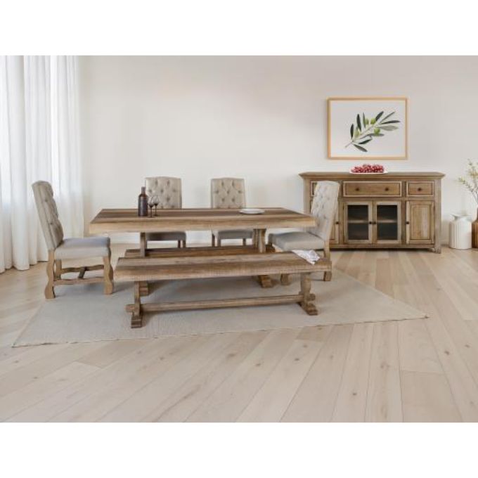 Dining room set with wooden table, chairs, and bench in a room with a painting on the wall. Marquez Dining chair available at Rustic Ranch Furniture and Decor.