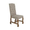 Beige upholstered chair with wooden legs on a white background. Marquez Dining chair available at Rustic Ranch Furniture and Decor.