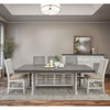 Dining room with a gray table and chairs in a well-lit room. Stone Ivory Chair with Fabric Seat available at Rustic Ranch Furniture and Decor.