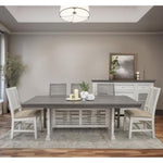 Dining room with a gray table and chairs in a well-lit room. Stone Ivory Chair with Fabric Seat available at Rustic Ranch Furniture and Decor.
