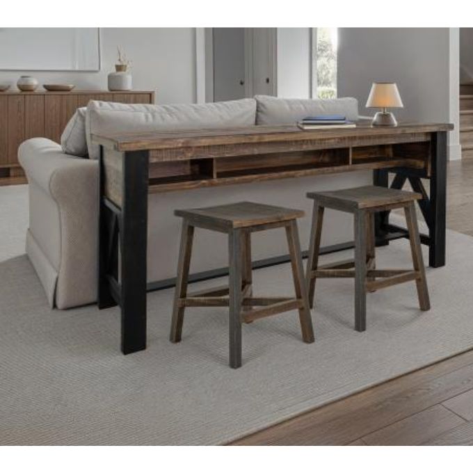 Wooden sofa table with black legs and two stools in a living room setting. Loft Brown Counter Height Sofa Table available at Rustic Ranch Furniture and Decor.