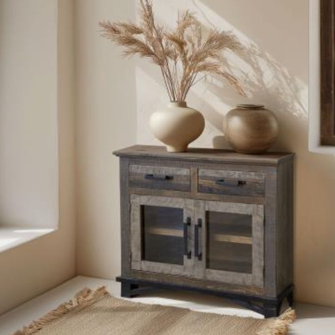 Wooden sideboard with decorative items in a room with natural light. Loft Brown Server - Cabinet available at Rustic Ranch Furniture and Decor.