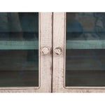 Close-up of a glass doors with wooden knobs.  Aruba Sky Blue Cabinet - TV Stand available at Rustic Ranch Furniture and Decor.